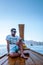 Young men traveling in longtail boat, Phangnga Bay Thailand ocean, famous for its many Islands and lagoon in the ocean