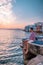 Young men on vacation Greece, Mykonos Greece, Little Venice Mykonos Greece, sunset at ocean fron at Mykonos town