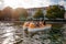 Young men and women boating in lake