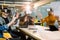 Young men and women sitting at a table with virtual reality goggles. Multiethnical business team testing virtual reality