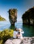 young men and women on vacation in Thailand Phannga watching the sunrise at James Bond Island