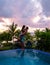 Young men and women watching sunset at the infinity pool at Saint Lucia Caribean