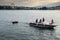 Young mens rest on boat on Geneva Lake at sunset time