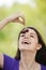 Young merry woman eating cherries