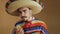 Young Mexican In Multicolored Poncho And Hat.