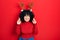 Young middle east woman wearing cute christmas reindeer horns gesturing finger crossed smiling with hope and eyes closed