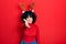 Young middle east woman wearing cute christmas reindeer horns smiling friendly offering handshake as greeting and welcoming