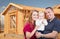 Young Military Family Outside Their New Home Framing