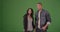Young millennial black couple walking together sightseeing on green screen