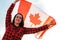 Young millennial brunette woman holding The National Flag of Canada. Canadian Flag or the Maple Leaf. Tourist traveler