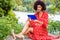 Young Mixed Race African American Woman with afro long curly hair traveling, relaxing at Central Park, New York City