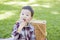 Young Mixed Race Boy Eating in Park Near Picnic Basket