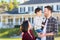 Young Mixed Race Caucasian and Chinese Family In Front of Custom Home