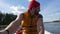 Young Mixed Race Caucasian Hipser Man Rowing Inflatable Boat with Wooden Oars on Lake. HD Slowmotion Lifestyle Footage.