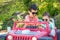 Young Mixed Race Chinese and Caucasian Brothers Wearing Sunglasses Playing In Toy Car