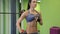 Young mixed race sports woman model with perfect muscular body posing in the gym.