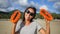 Young Mixed Race Vegan Girl Dancing with Thai Orange Papaya on the Beach. Koh Phangan, Thailand. HD Slowmotion.