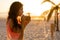 Young mixed race woman drinking cocktail on beach