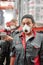 Young mixed-race woman in workwear and respirator standing in front of camera