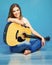 Young model girl with acoustic guitar