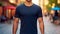 Young model shirt mockup, boy wearing blue t-shirt on street in daylight. Shirt mockup template on hipster adult for design print