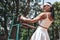 young model wearing fashionable tennis dress, posing on tennis judge umpire chair