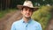 Young modern confident cowboy looking at camera in countryside