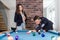 Young modern couple in love playing pool table billiard game