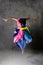 Young modern dancing girl in colorful dress