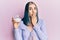 Young modern girl holding bowl with sugar covering mouth with hand, shocked and afraid for mistake