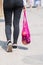 A young modern woman with purchases. Girl carries fruits and vegetables in an eco-friendly string, reusable net bag. Organic