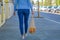 A young modern woman walks down the street with fruits and vegetables