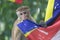 Young monkey playing with buddist flag