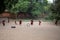 Young monks plays with a tire and throwing stick through it