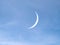 Young moon on light blue sky