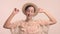 A young Moroccan woman wears a hat in the studio and monochrome makeup