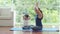 Young mother applauded to her daughter while teaching yoga