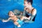 Young mother and baby relaxing in the swimming pool