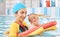 Young mother and baby son are in pool teaches swim