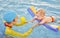 Young mother and baby son are in pool teaches swim