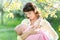 Young mother breast feeding baby in garden