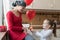 Young mother, cancer patient, and her cute daughter, celebrating birthday with balloons and presents.