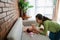 Young mother cleaning between finger folds of little girl