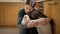 Young mother comforting and calming her daughter crying on floor at kitchen. Concept of domestic violence and family