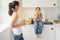 Young mother cooking tasty corn for children