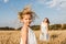 Young mother and daughter dance in field