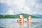 Young mother and daughter have fun swim on island in tropical ocean