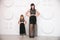 Young Mother with daughter in identical dresses on white background