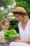 Young mother and daughter with lettuce