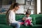 Young mother with daughter looking in opened box